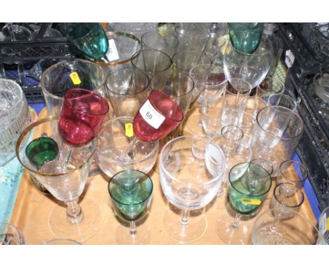 An assortment of drinking glasses including two with ruby bowls and three with green glass bowls