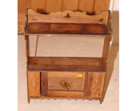 A stripped pine wall shelf/cupboard enclosed panel door with gilt edge leaf decoration, 16" wide