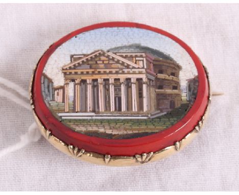 A 19th Century oval micro mosaic panel decorated view of the Pantheon with red border and yellow metal brooch mount