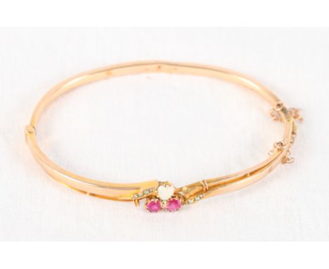 A 9ct gold bangle set ruby, opal and seed pearl