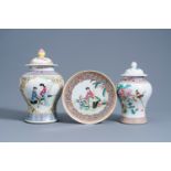 Two Chinese famille rose vases and covers and a plate with figures in a garden, Republic, 20th C.