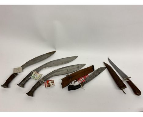 Five Eastern design Kukri and other knives, to include a Malay Parang knife with wooden scabbard, a Nepalese Kukri with all s