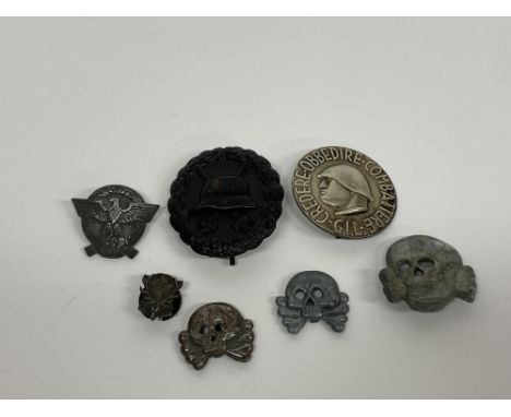A German Wound badge in black, an Italian G. I. L. pin badge stamped 'Castelli, Milano' verso, three German S.S. visor cap sk