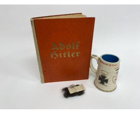 A bag of horsehair stuffing, the label within reading 'Stuffing out of Hitler's Chair in Bunker', a Luftwaffe beer stein and 