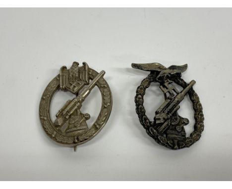 A German Army Flak badge and an anti-aircraft badge, no markings to the pinned rears