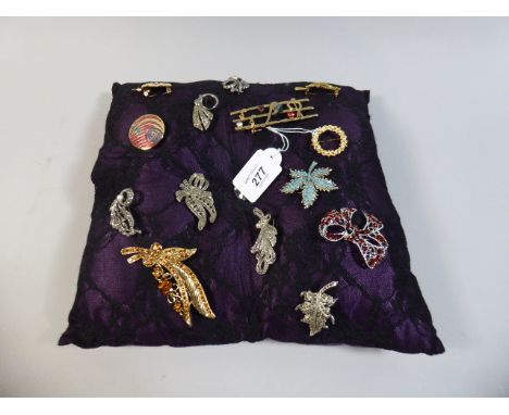 A Cushion Mounted with Fourteen Brooches