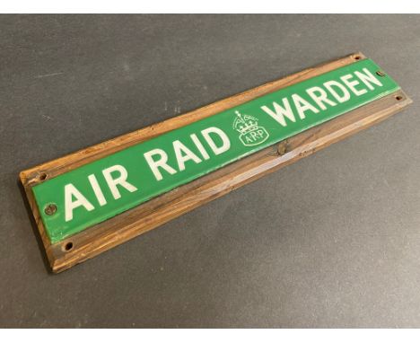 A small Air Raid Warden enamel strip mounted on wood, 9 1/4 x 2 1/4". 