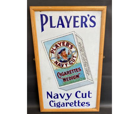 A Player's Navy Cut Cigarettes pictorial packet enamel sign in a frame, mounted on a board, two small spots of old amateur re