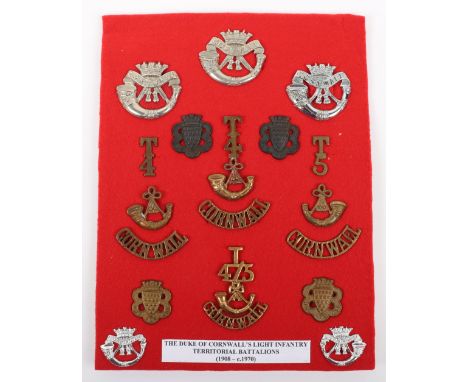 Badges of the Territorial Battalions of the Duke of Cornwall Light Infantry, including various cap badges, territorial collar