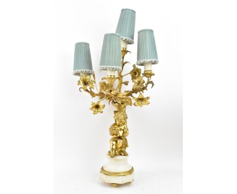 A 19th century Louis XV style ormolu and marble table lamp, converted from a candelabrum, fashioned as child leaning against 