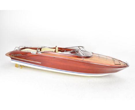 A scale model of a Riva Rama speedboat, varnish finished with cream leather upholstered seats and chrome fittings, 20cm high 