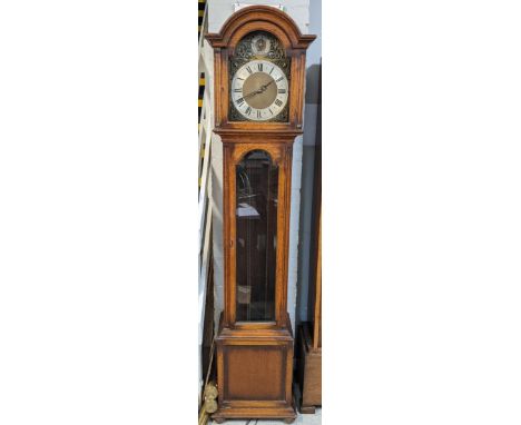 An early/mid 20th century oak longcase clock having a selection dial for Westminster, St Michael and Whittington, striking on