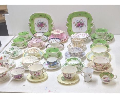 A mixed lot of Victorian and later cups and saucers to include a Coalport cup and saucer decorated with dragons and birds, to