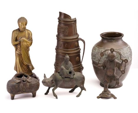 A Chinese cast brass figure of standing Buddha, late Qing, the bearded figure with tight curls and an urna to the forehead, s