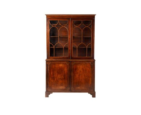 A George III and later mahogany bookcase cabinet, the moulded cornice above a pair of glazed doors with arched glazing bars o