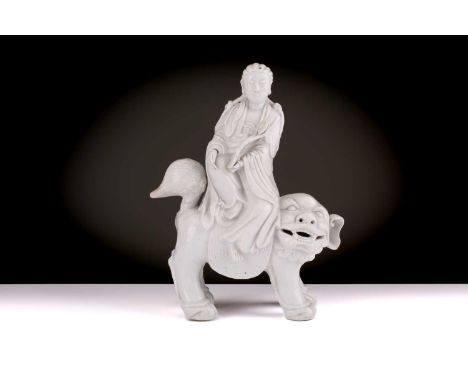 A Chinese Dehua blanc de chine figure of Guanyin, Qing Dynasty, Kangxi, late 17th century, seated in lalitasana holding a ruy
