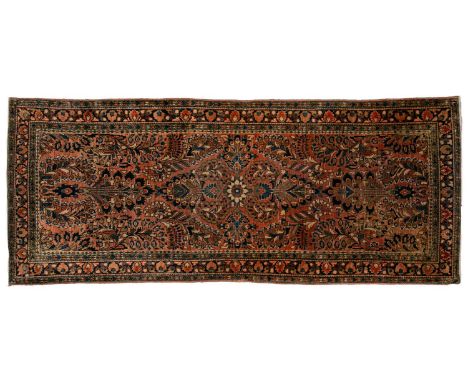 An old Sarouk short runner with sprays of flowers on a pink ground within multiple borders,191 cm x 78 cm