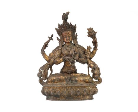 A Chinese Sino Tibetan style bronze Tara, seated in dhyanasana, the six arms with attributes, traces of red pigment and gildi