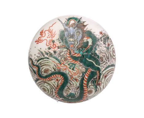 A Chinese porcelain famille verte bowl and cover, painted with a writhing dragon amongst spuming waves, the underside of the 