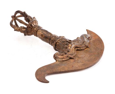 A Chinese Sino Tibetan bronze Kartika, the finial formed of four uniting masks and tongues, a dragon mouth housing the lade, 