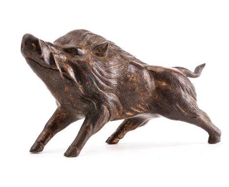 A Chinese bronze figure of a boar, standing on all fours sniffing the air, traces of gilt and red pigment, approx 26cm long, 