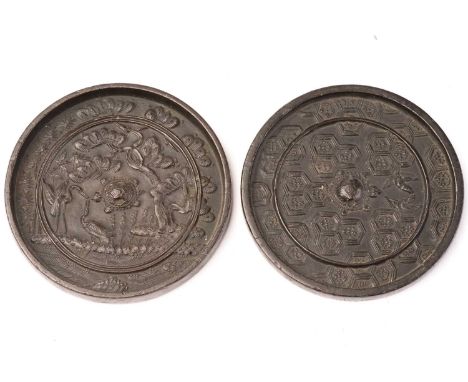 A Chinese bronze mirror, Qing, 19th century, with central pierced boss formed as a tortoise, surrounded by two cranes and fol