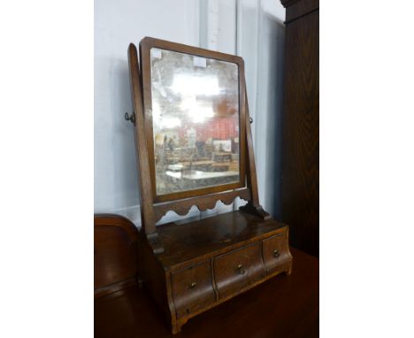 A George I walnut three drawer toilet mirror and a George III mahogany framed mirror 