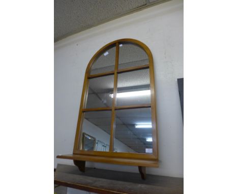 A mahoganay framed cathedral style mirror 