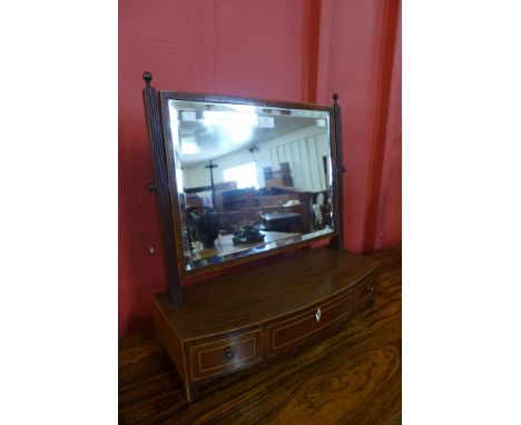 A George IV style inlaid mahogany three drawer toilet mirror 