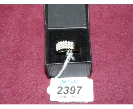 A yellow metal ring set with twenty small simulated diamonds and a simulated seed pearl, size "S" approx.