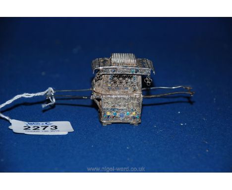 A small and dainty Chinese silver model of a sedan chair with coloured enamel detail, a/f.