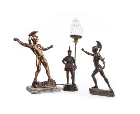 BRONZED CAST METAL LAMP, in the form of a Roman soldier, with frosted flaminf torchglass shade, on a wooden base, 55cm high o