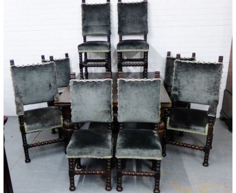 An oak dining suite comprising a set of eight bobbin turned chairs to include a pair of carvers, each with upholstered back a