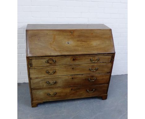 A 19th century mahogany bureau, the fall front opening to reveal a fitted interior, over pull out slides and set of four long