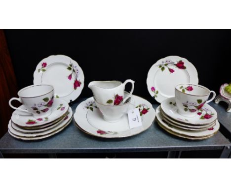 A Cmielow Polish porcelain teaset with rose pattern and gilt rims comprising six cups, six saucers, six side plates, cream ju