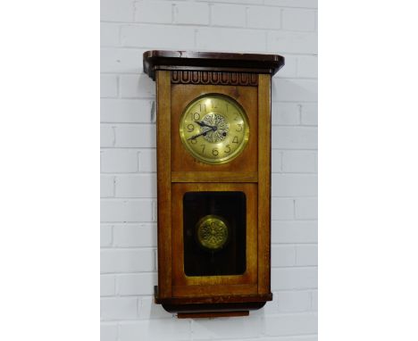 An oak wall clock with brass dial 75 x 40cm 