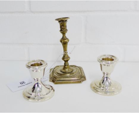 A pair of Birmingham silver desk candlesticks, 6cm high, together with a London silver knop stemmed candlestick 11cm high (3)