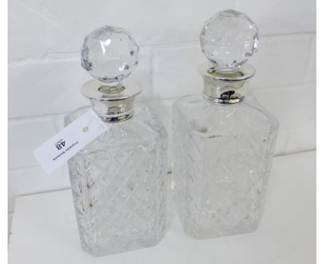 A Mappin & Webb silver collared and hobnail cut glass spirit decanter and stopper together with another similar (2) 