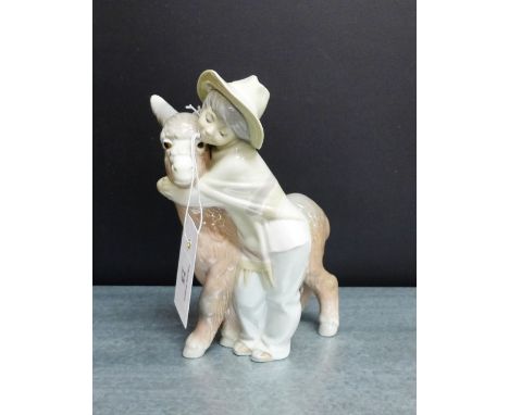 A Lladro porcelain figure of a boy and a donkey, 20cm high