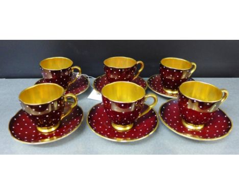 A Carlton ware polka dot patterned Art Deco coffee set of six cups and saucers with a red ground and gilt interiors comprisin