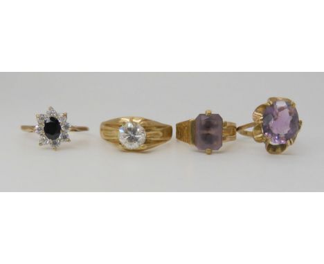 Four 9ct gold gem set rings, oval amethyst, size approx L, sapphire and cz flower cluster, size O1/2, large cz ring, size U, 