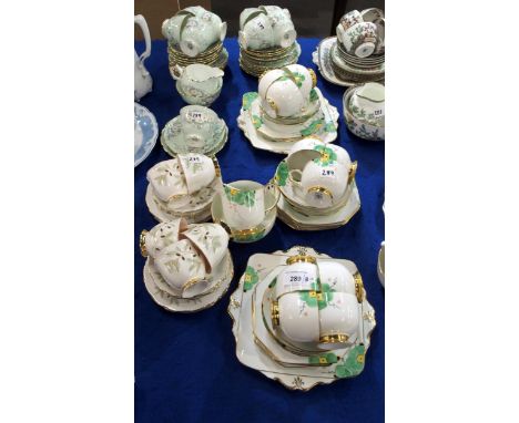 A Paragon hand painted teaset comprising ten cups, twelve saucers and eleven plates, milk jug, sugar bowl and two cake plates