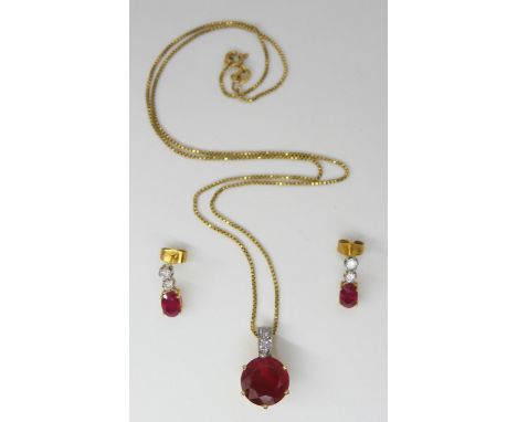 An 9ct gold ruby and diamond pendant, set with 0.07cts of diamonds, with an 18ct box chain length 44cm, together with matchin