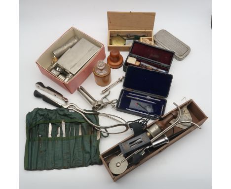 A quantity of vintage medical equipment, including a glass vessel in treen screw-top case, forceps, cased syringes, chemist's