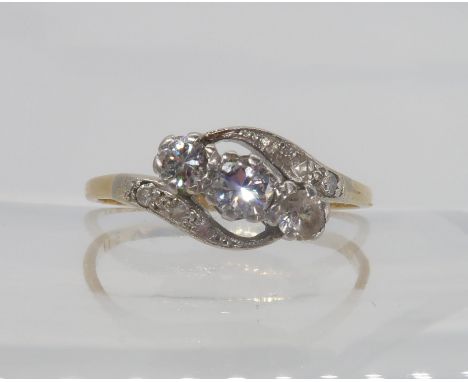 A vintage three stone on a twist ring, set with estimated approx 0.30cts of brilliant cuts (one has been replaced with a clea