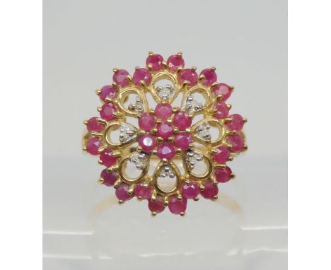 A 9ct gold ruby and diamond cluster ring the diameter of the front is 19mm, finger size P1/2, weight 3.7gms Condition Report: