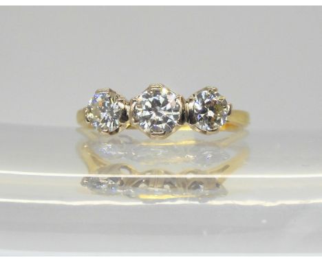 An 18ct gold three stone diamond ring, set with estimated approx 1ct of brilliant cut diamonds. Finger size N, weight 3.3gms 