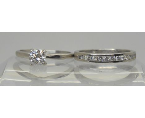 A platinum prong set diamond solitaire, of estimated approx 0.50cts, finger size M, together with a platinum diamond set comp