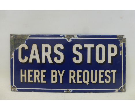 A 'Cars Stop Here By Request' rectangular enamel sign, 14 3/4 x 7 1/4".