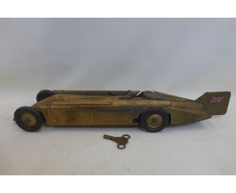 A Kingsbury Golden Arrow clockwork tinplate landspeed record car, with key. 